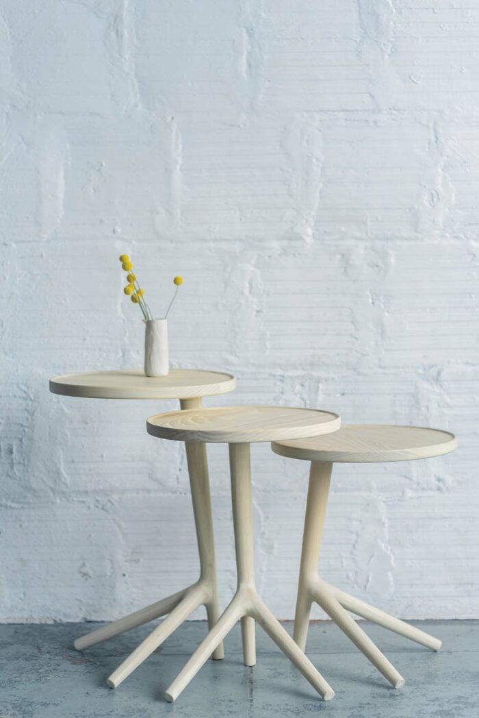 Unique round tripod tables by Justin Nelson