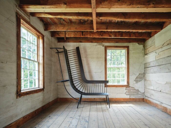 windsor bench sculpture, curved and half on floor half on wall