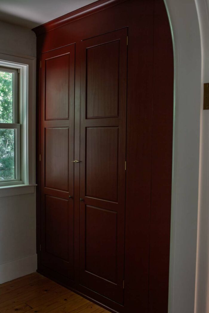 large and tall red painted wood cabinet by Brian Persico