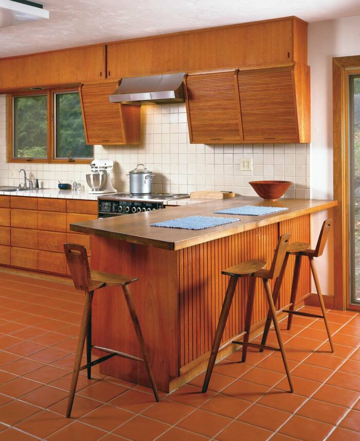 Kitchen with wood counter table and barstools all designed by tage frid