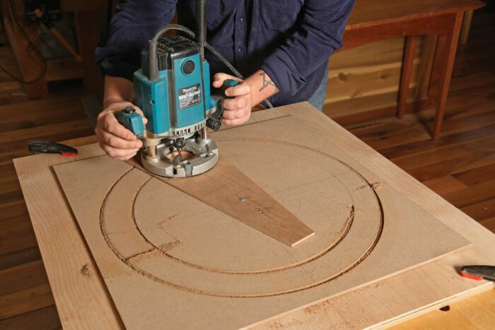 Routing a circle with a trammel in a piece of MDF