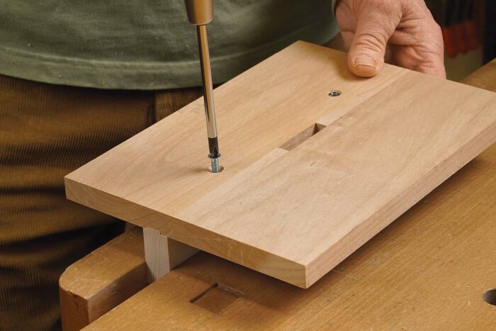 Add the fence. The fence is tenoned to fit a groove in the template. Attached with screws, it can be removed and replaced accurately.