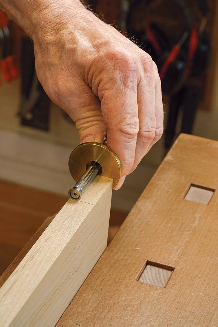 Just one layout mark needed. Mark a line where the square end of the hinge will land—in this case, 199⁄1616 in. from the edge of the door strip.