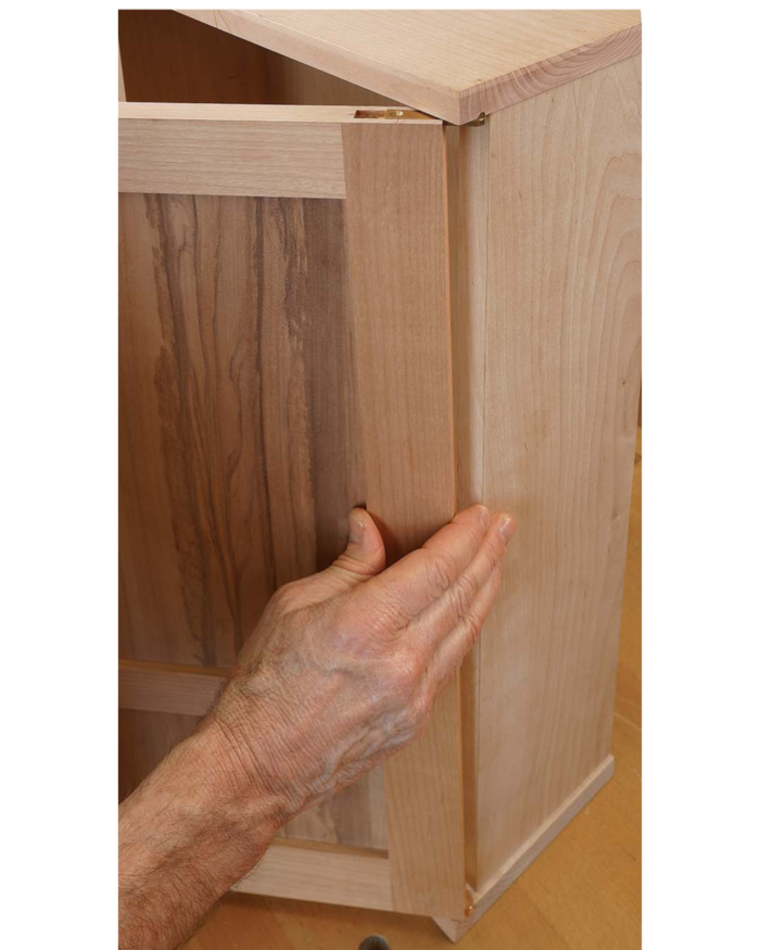 Slide the door onto its hinges.